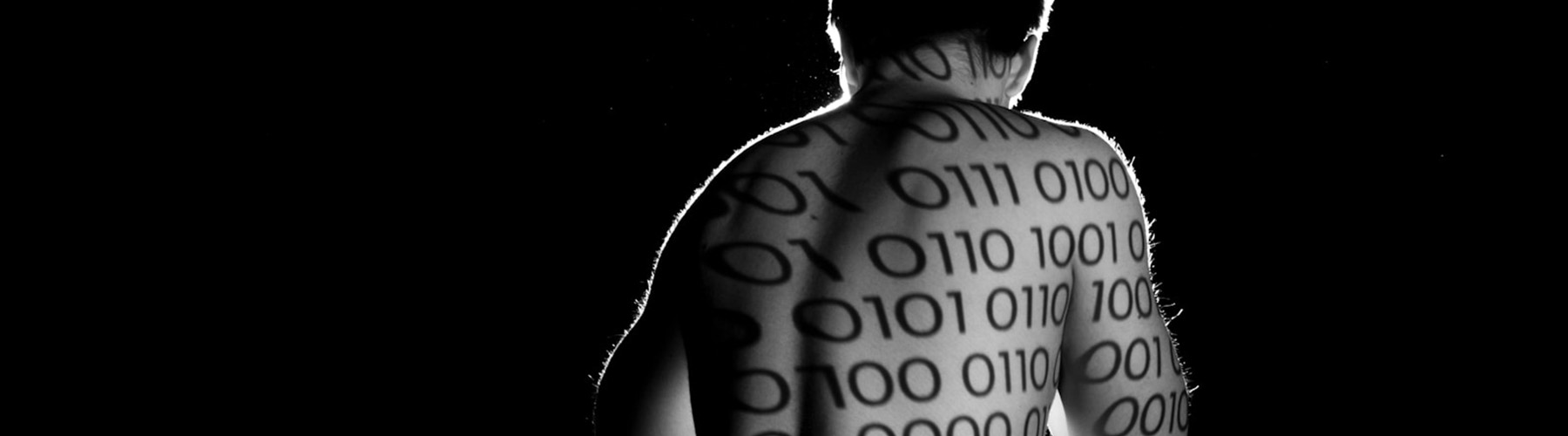 Figure with ones and zeros projected onto bare back.